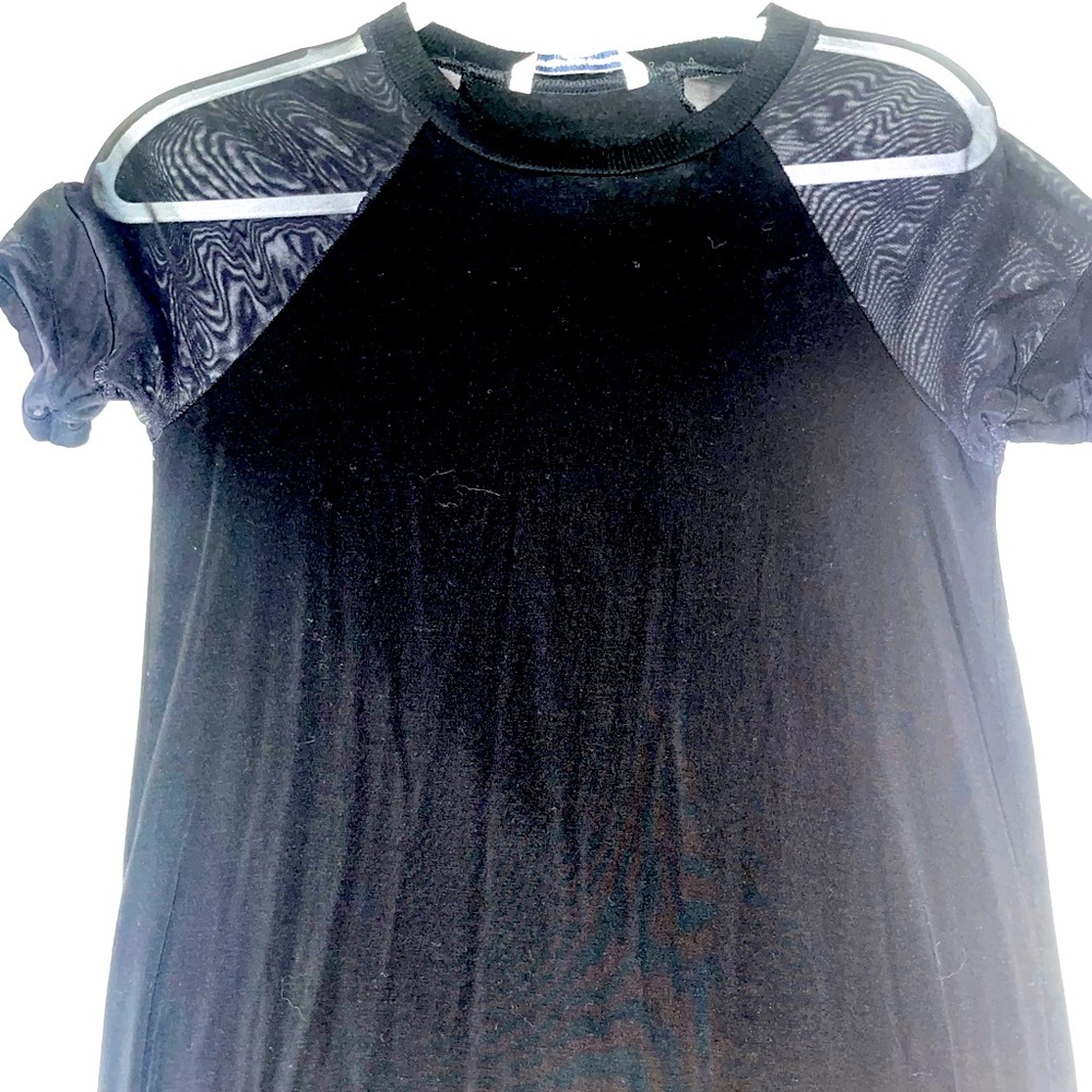This is a mini black dress with sheer sleeves.